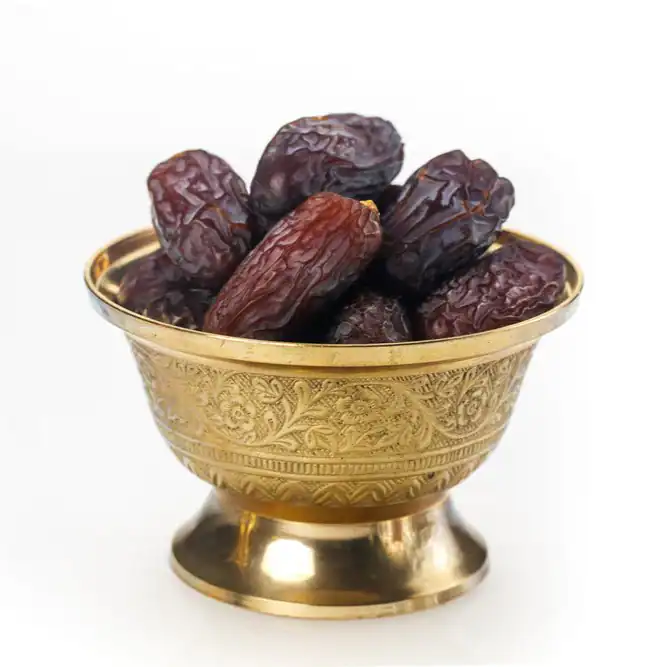 Premium Mabroom dates in a bowl, long slender brown dates with a firm chewy texture